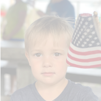 young child holding USA flag